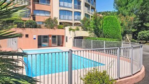 A multi-story residential building with balconies, a swimming pool, and surrounding greenery. - Résidence Les Sangliers by Interhome (Saint-Raphaël)