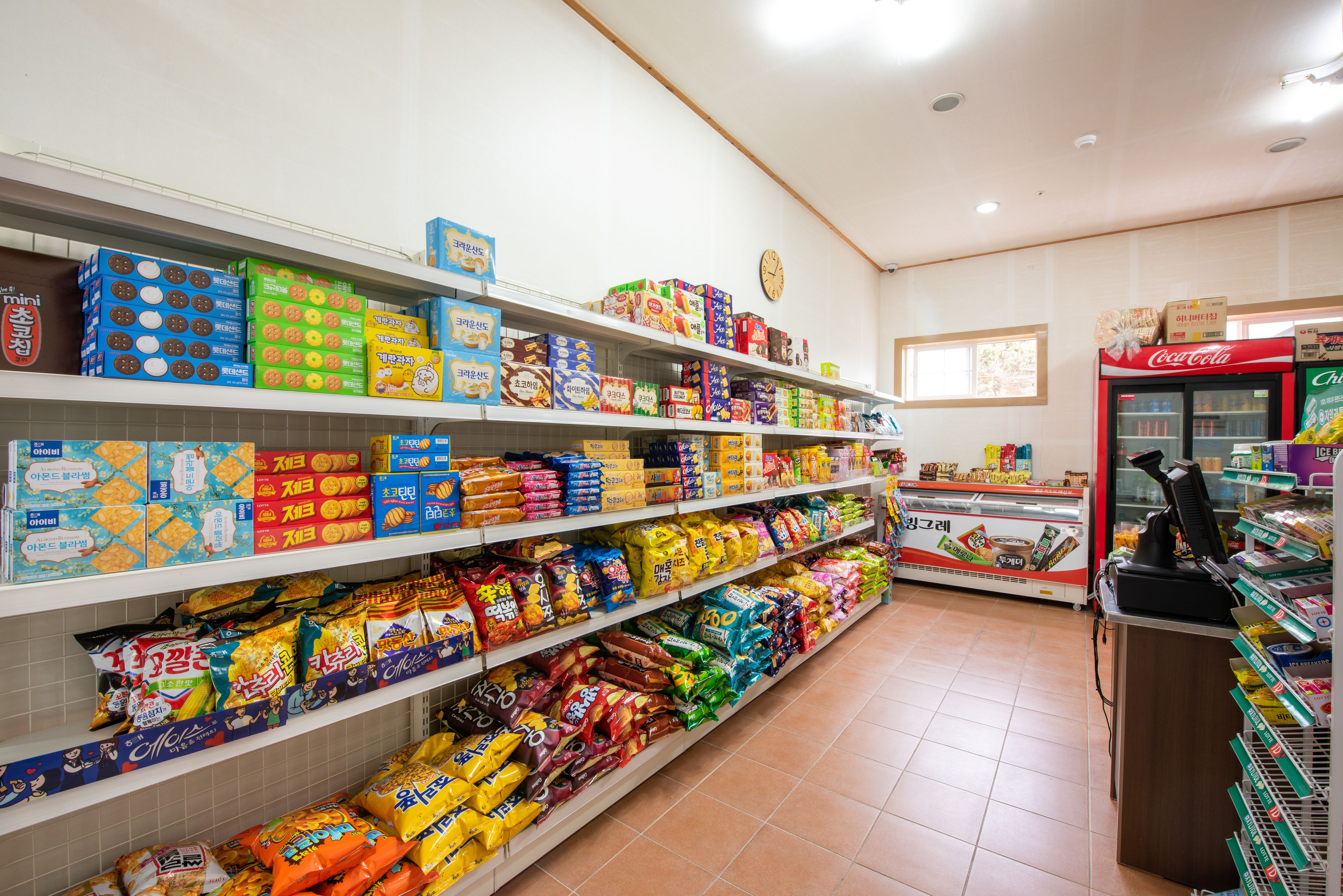 A grocery store with shelves stocked with various snacks and packaged goods.
