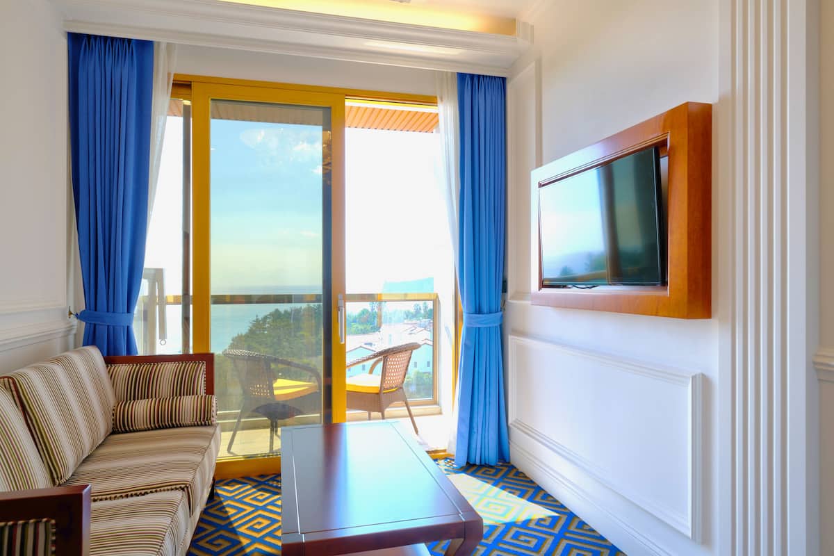 ocean view suite with jacuzzi | living room | 40-inch flat-screen tv with cable channels, netflix, toys