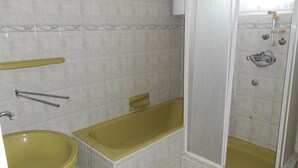 A bathroom with a bathtub, a sink, and a shower. - Apartments in Heviz / Thermal Lake / Hungary (HÉVÍZ)