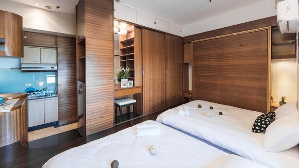 A modern hotel room with a kitchenette, two beds, a large wardrobe, and a bathroom. - Love Taipei - Ximen (Taipei)