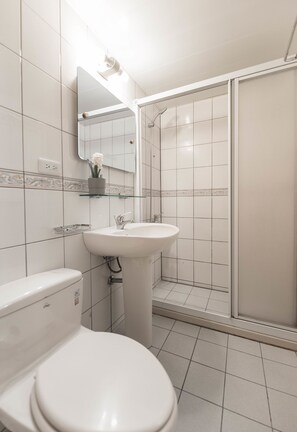 A bathroom with a toilet, sink, and glass-enclosed shower. - Love Taipei - Ximen (Taipei)