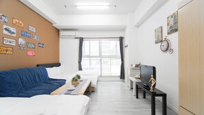 A hotel room with a bed, a desk, a television, and a window with curtains. - Love Taipei - Ximen (Taipei)