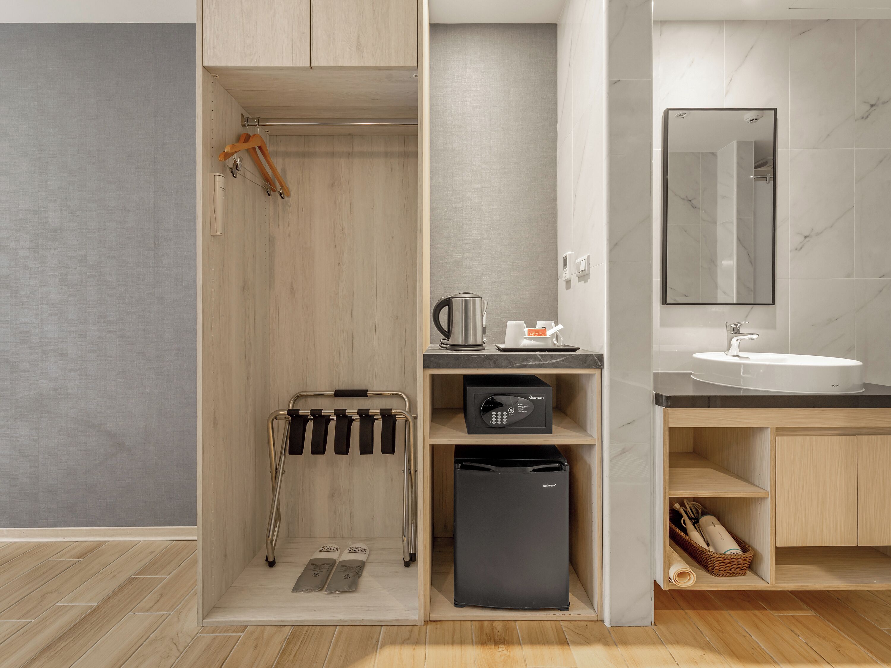 A modern bathroom with a shower, a sink, and a compact refrigerator.
