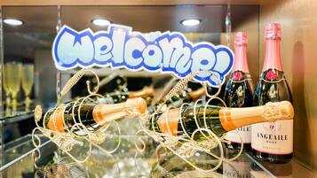 A display of champagne bottles with a 'Welcome!' sign in the background.