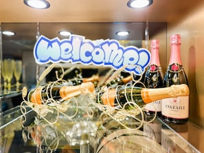 A display of champagne bottles with a 'Welcome!' sign in the background. - Hotel Rocks (Tokyo)
