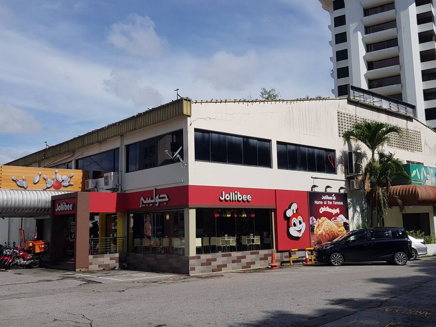 A two-story building with a Jollibee restaurant on the ground floor.