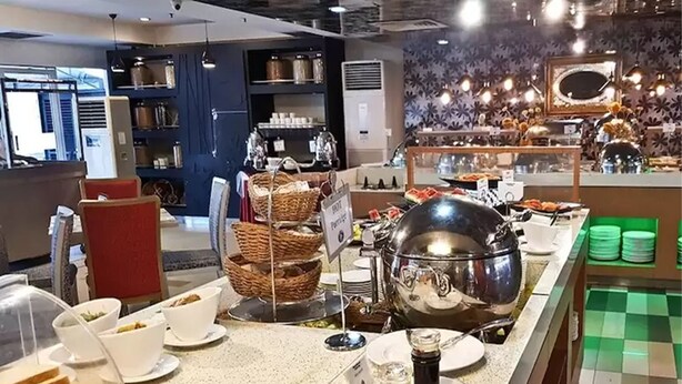 A buffet setup with various food items and serving utensils. - The Centrepoint Hotel (Bandar Seri Begawan)