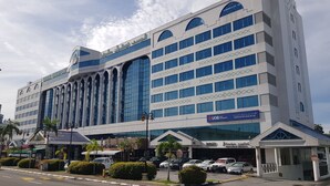 A modern building with multiple floors, large windows, and a UOB Asset Management sign. - The Centrepoint Hotel (Bandar Seri Begawan)