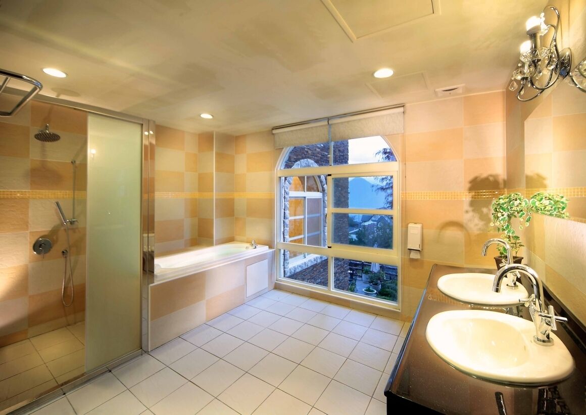 deluxe family room | bathroom | shower, hair dryer, towels, shampoo