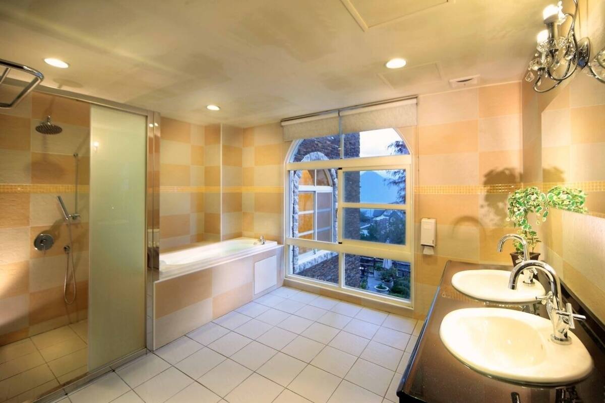 deluxe family room | bathroom | shower, hair dryer, towels, shampoo