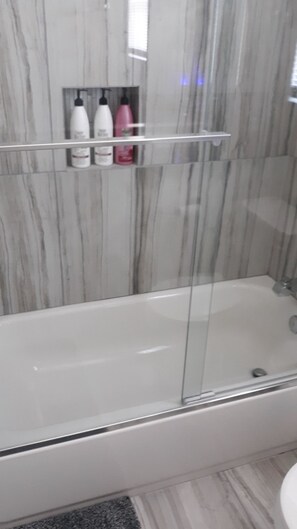 Slaapzaal | Badkamer | Een bad/douchecombinatie, een diep bad, een regendouche