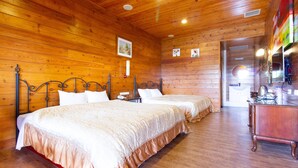 A wooden-paneled room with two beds, a dresser, and a mirror. - Liching Garden Villa (Ren'ai)