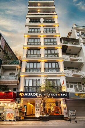 A multi-story hotel with balconies, a spa, and a restaurant. - Aurora Premium - A Lifestyle Hotel (Hanoi)