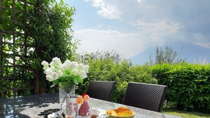 A table set outdoors with a clear view of a mountain in the background.