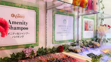 A hotel display with various amenities including a sign for 'Amenity Shampoo' and a selection of products on shelves.