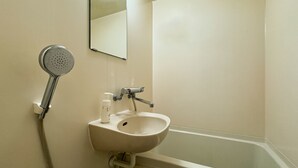 A bathroom with a sink, mirror, shower, and a bottle of hand soap. - Hotel Century (Chiba)