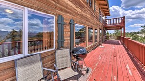 A wooden cabin with a deck, large windows, and a barbecue grill. - Secluded Cotopaxi Cabin w/ Panoramic Mtn Views (Cotopaxi)