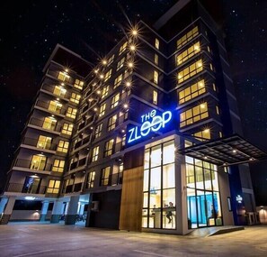 A modern building with multiple floors, a prominent illuminated sign reading "The ZLOOP," and a glass entrance area. - The Zleep Chonburi (Chonburi)