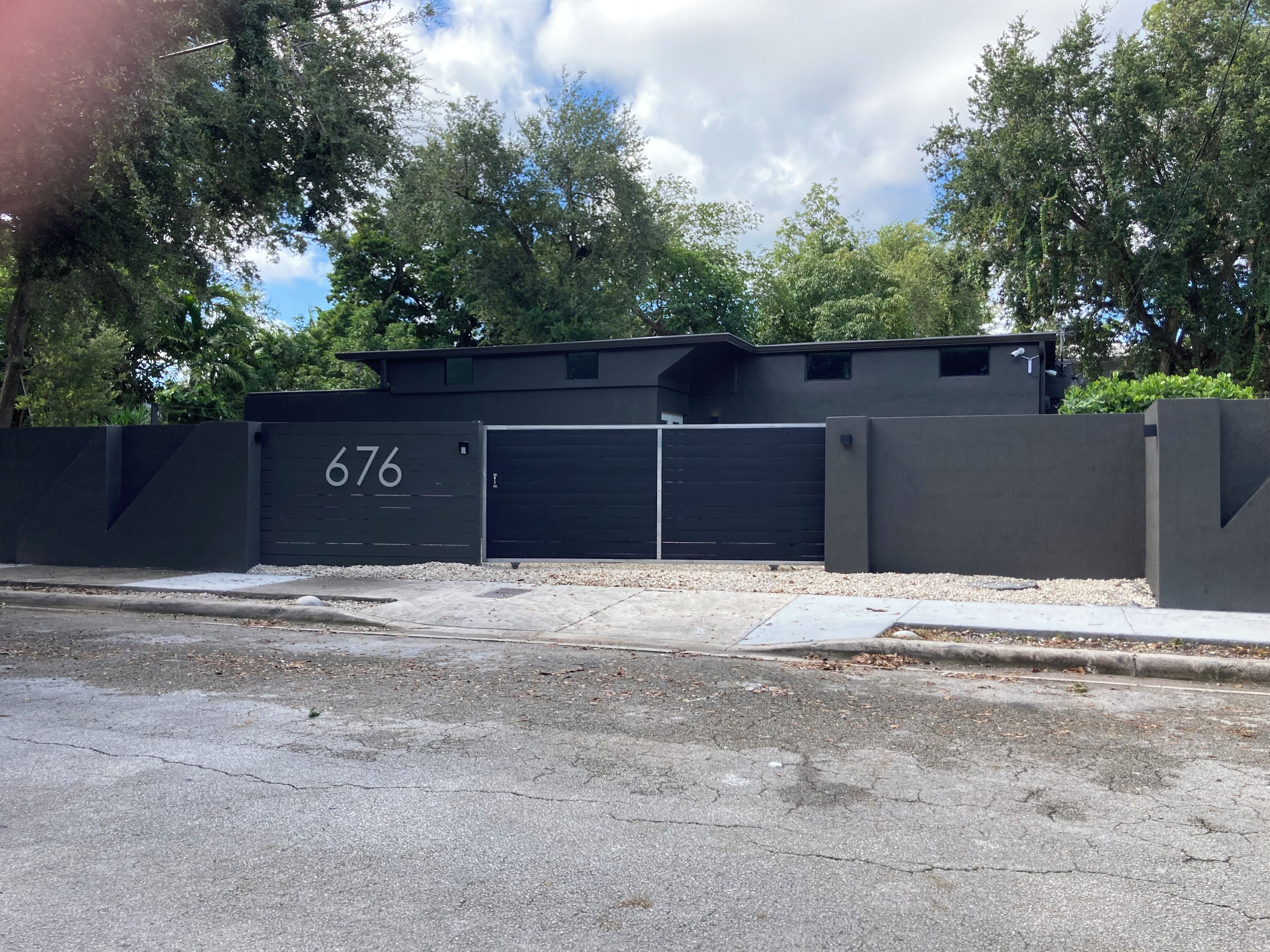 A gated parking area with a garage door marked with the number 676.