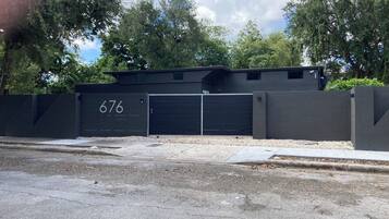 A gated parking area with a garage door marked with the number 676.