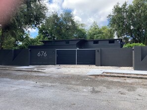 A gated parking area with a garage door marked with the number 676.