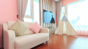 A living room with a sofa, a television, and a teepee. - Beautiful Village (Wujie)