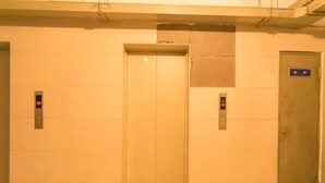 An elevator with two doors, each with a digital display showing numbers. - Yi Xin Apartment - Hostel (Xi'an)