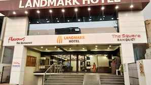 The exterior of Landmark Hotel with a sign for 'flavours The Restaurant' and 'The Square Banquet' below.