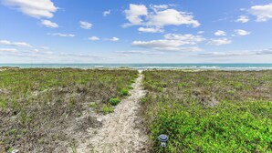 A coastal path leading to the sea with a clear sky. - SHARE A HEAVENLY VACATION with your family, friends, and pets! (St. George Island)