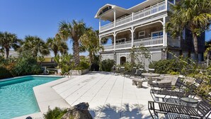 A two-story building with a pool and outdoor seating area. - You will delight in the fabulous gulf views from this elegant, Nantucket style beach home! (St. George Island)