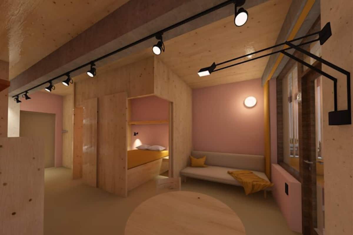 A modern interior with a bunk bed, a sofa, and a round table.