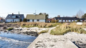 A coastal area with houses, sandy beach, and a concrete path. - Amazing home in Borrby with WiFi (Borrby)