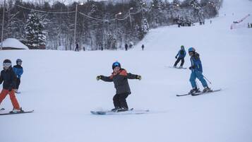A ski slope with skiers and snowboarders.