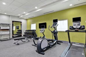 A gym with treadmills, an elliptical, and dumbbells. - Home2 Suites by Hilton Pecos (Pecos)