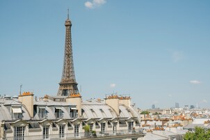 A view of the Eiffel Tower with surrounding Parisian architecture.