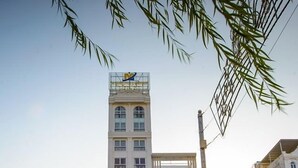 A modern building with a tall structure and a shorter section below. - The Shine Office and Apartment (Hai Phong)