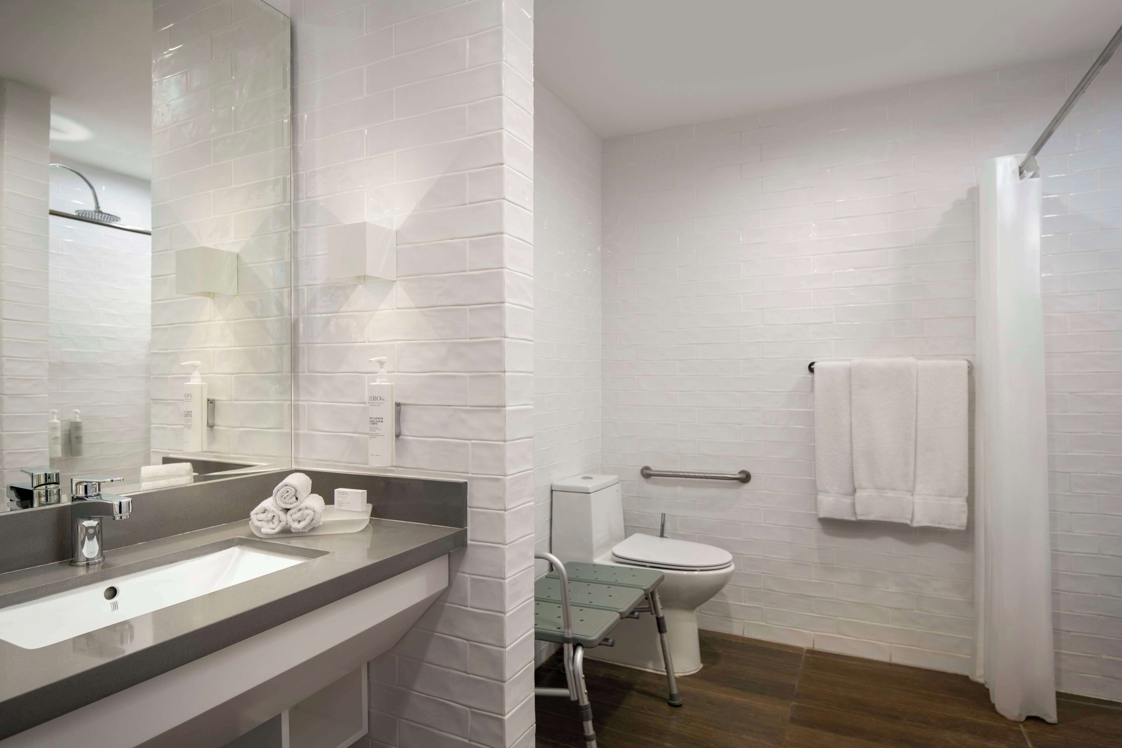 studio, 1 queen bed, accessible (roll-in shower) | bathroom | combined shower/bathtub, designer toiletries, hair dryer, towels