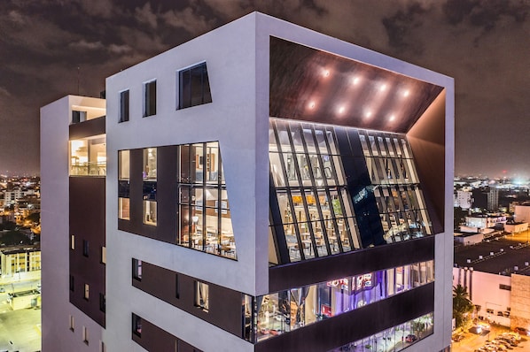 A modern multi-story building with large windows and a unique architectural design. - Homewood Suites by Hilton Santo Domingo, Dominican Republic (Santo Domingo)