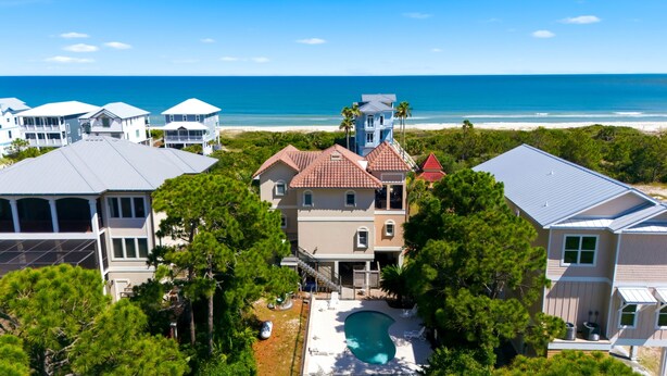 A residential area with multiple houses, a swimming pool, and a beach view. - Welcome to Sea La Vie! (St. George Island)