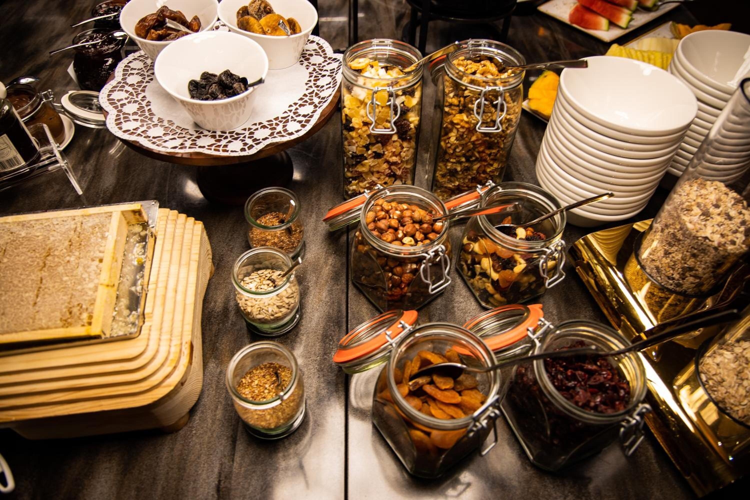 A buffet table with various food items and containers.