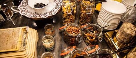 A buffet table with various food items and containers.