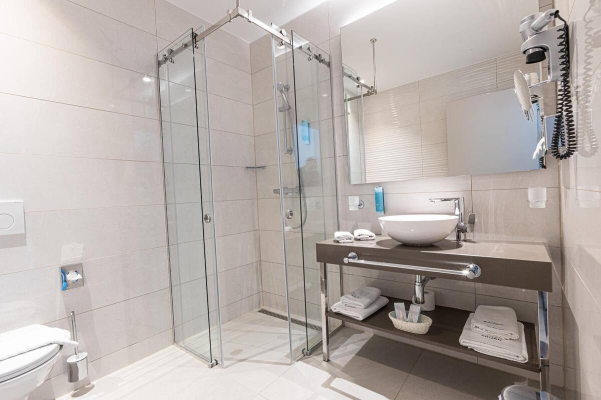 shower, hair dryer, towels, soap