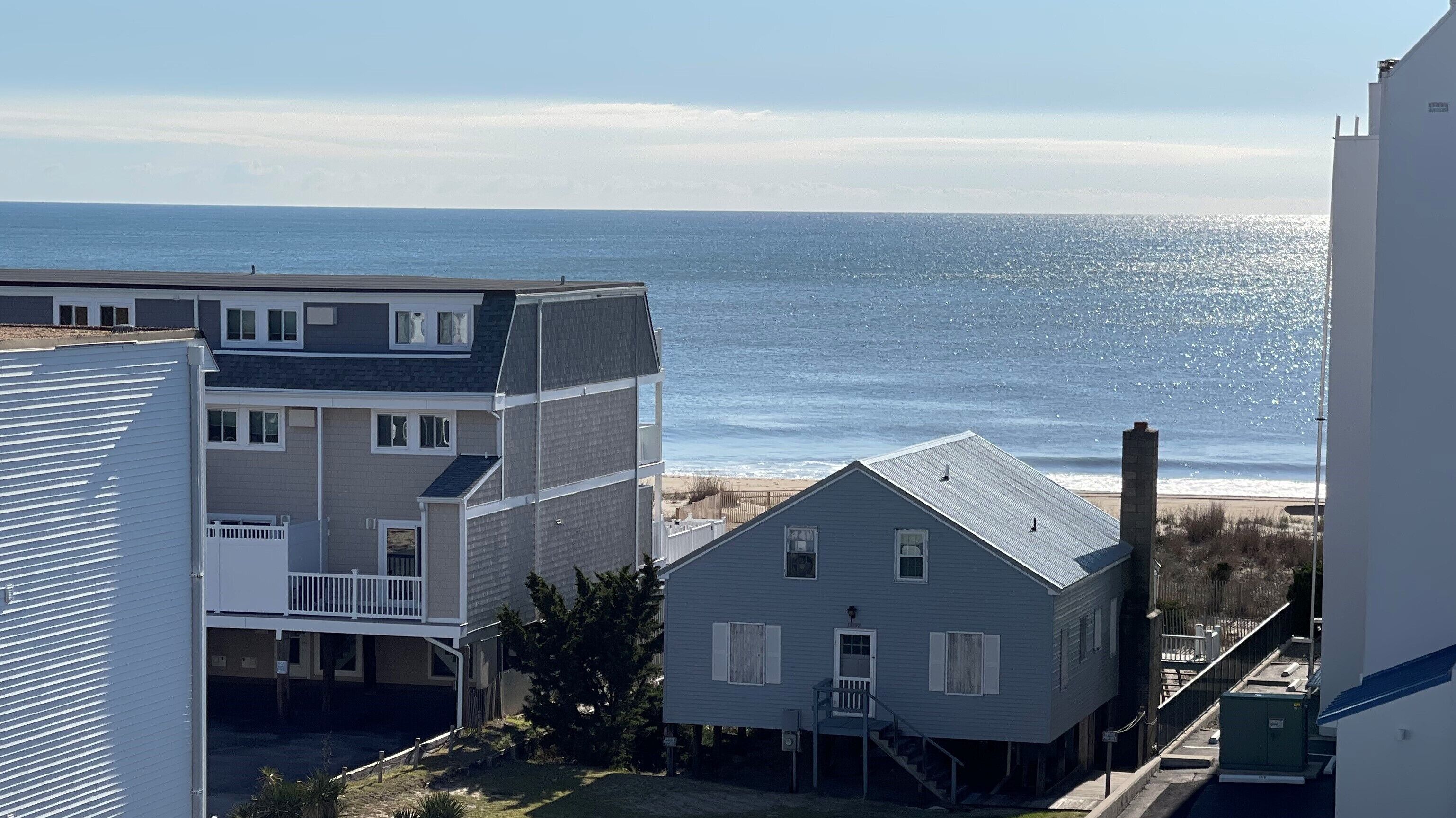 A coastal residential area with houses overlooking the beach.