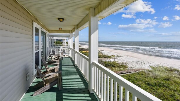 A covered porch with a view of the beach. - LET AN IRISH SEABREEZE WISK YOUR CARES AWAY! (St. George Island)