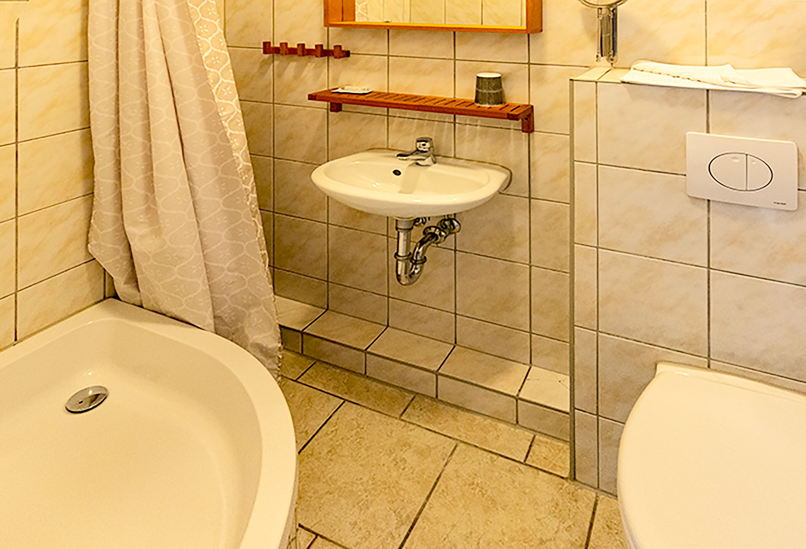 A bathroom with a bathtub, a sink, and a toilet.