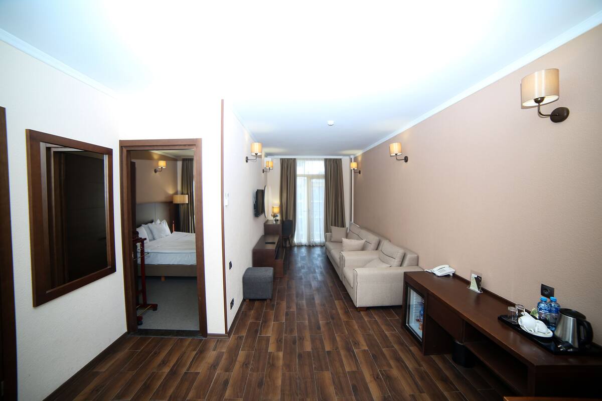 Family Suite, City View | Living area | Flat-screen TV
