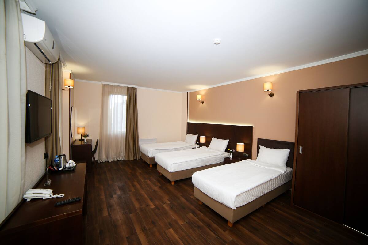 Standard Triple Room, City View | In-room safe, desk, laptop workspace, blackout drapes