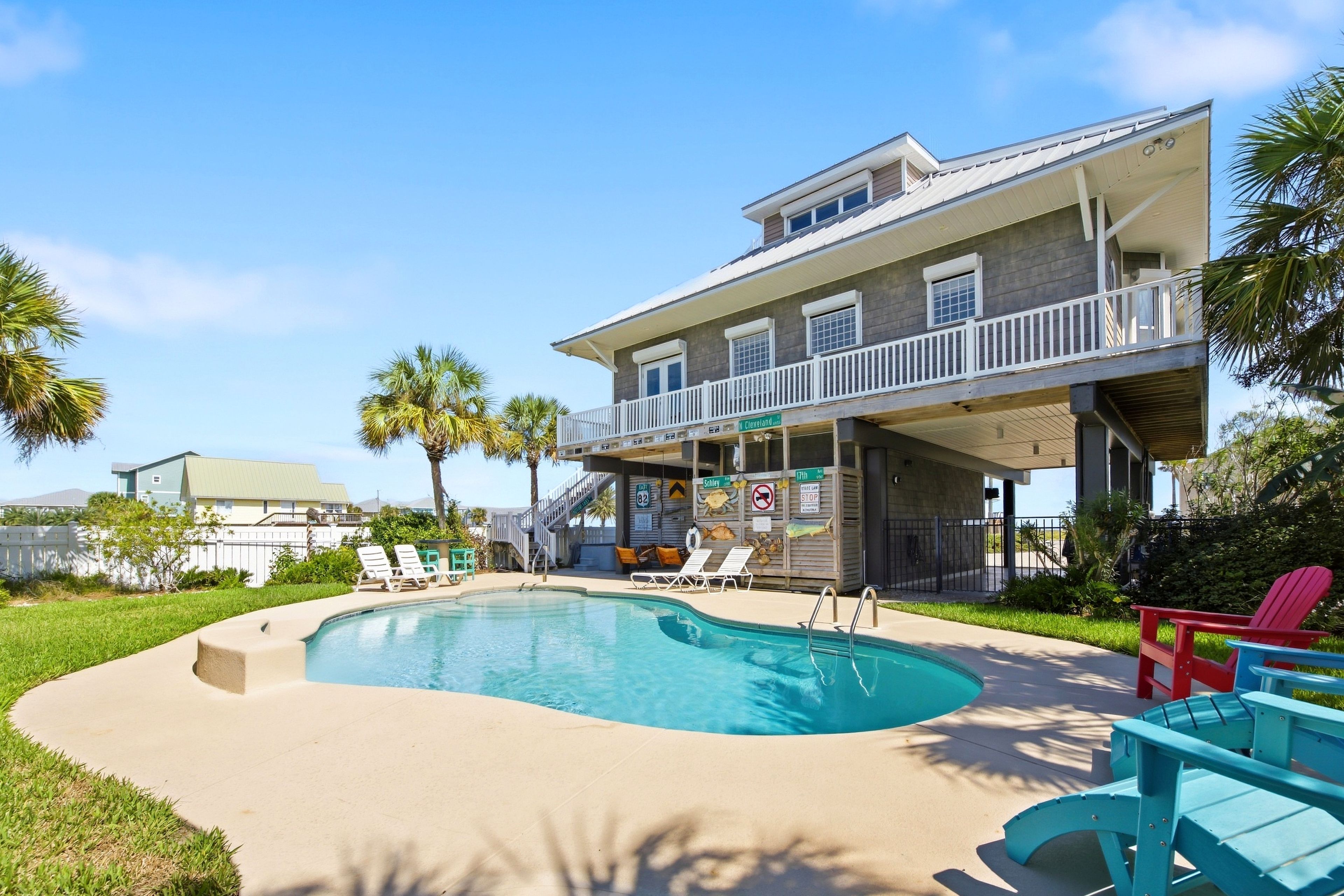 A two-story building with a pool, outdoor seating, and a covered area with a sign indicating 'N. Cleveland Ave.'