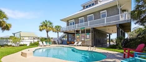 A two-story building with a pool, outdoor seating, and a covered area with a sign indicating 'N. Cleveland Ave.'